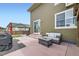 This backyard features a patio, a seating area with an outdoor couch and coffee table, and a sliding glass door at 1853 Griffin Dr, Brighton, CO 80601