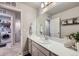 Bathroom with vanity, sink and laundry access at 1853 Griffin Dr, Brighton, CO 80601