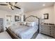 Main bedroom with plush carpet, ceiling fan, and en-suite bathroom at 1853 Griffin Dr, Brighton, CO 80601