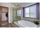 Luxurious bathroom features a soaking tub, a separate shower, and a bright window at 1825 Keota Ln, Superior, CO 80027