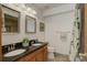 Bathroom with a double vanity, framed mirrors, and a shower with decorative curtain at 1825 Keota Ln, Superior, CO 80027