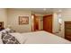 Cozy bedroom with a large bed, closet space, and a decorative headboard with flowers at 1825 Keota Ln, Superior, CO 80027