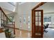 Bright and open foyer with hardwood floors, decorative front door, and staircase with iron railing at 1825 Keota Ln, Superior, CO 80027