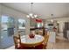 Bright kitchen nook with a wooden table, light fixture, stainless steel appliances, and sliding door to the deck at 1825 Keota Ln, Superior, CO 80027