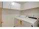 Well-organized laundry room, showcasing a modern washer and dryer set, along with overhead storage cabinets at 1825 Keota Ln, Superior, CO 80027
