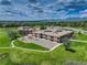 Aerial view of school building with playgrounds, set against a backdrop of rolling hills and partly cloudy skies at 1825 Keota Ln, Superior, CO 80027