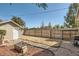 Fenced backyard with wood fire pit and shed at 4804 N Raleigh St, Denver, CO 80212