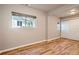 A simple bedroom with hardwood floors and a window providing ample natural light at 4804 N Raleigh St, Denver, CO 80212