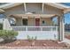 Close-up of the porch with an arched doorway, white railing, and lush landscaping at 4804 N Raleigh St, Denver, CO 80212