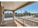 View of a street from the covered front porch with a white railing at 4804 N Raleigh St, Denver, CO 80212
