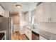 Updated kitchen with granite counters, stainless appliances, and white cabinetry at 4804 N Raleigh St, Denver, CO 80212