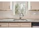 Bright kitchen sink featuring granite counters, a stainless steel faucet, and subway tile backsplash at 4804 N Raleigh St, Denver, CO 80212