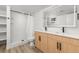 Bright bathroom featuring double vanity, large mirrors, modern fixtures, and a tiled shower with glass door at 11241 W 60Th Ave, Arvada, CO 80004