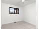 Bright bedroom with black trim window and neutral carpet, with a modern ceiling fan at 11241 W 60Th Ave, Arvada, CO 80004