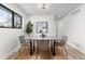 Chic dining room with modern lighting and minimalist decor. Window provides ample natural light at 11241 W 60Th Ave, Arvada, CO 80004