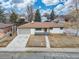 Exterior elevation features a well-maintained lawn, attached garage, and classic design elements at 11241 W 60Th Ave, Arvada, CO 80004