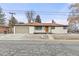 Front exterior features a white brick facade, new front door, and attached garage at 11241 W 60Th Ave, Arvada, CO 80004