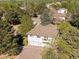 Aerial view of a home with an attached garage and a balcony surrounded by green trees at 3351 S Field St # 150, Lakewood, CO 80227