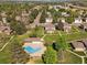 Aerial view of a community swimming pool surrounded by green lawns and residential buildings at 3351 S Field St # 150, Lakewood, CO 80227