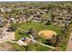 Community aerial view showcases green spaces, walking paths, and residential buildings in a neighborhood setting at 3351 S Field St # 150, Lakewood, CO 80227