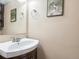 Powder room featuring a dark vanity, above-counter sink and artwork on the walls at 3351 S Field St # 150, Lakewood, CO 80227