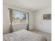 Bright bedroom featuring a large window providing natural light and neutral walls and carpet at 3351 S Field St # 150, Lakewood, CO 80227