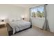 Cozy bedroom with a large window providing natural light and carpeted floors at 3351 S Field St # 150, Lakewood, CO 80227
