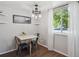 Bright dining area with modern light fixture, shelving, and natural light at 3351 S Field St # 150, Lakewood, CO 80227