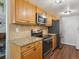 Well-equipped kitchen with stainless steel appliances, granite countertops and wood cabinets at 3351 S Field St # 150, Lakewood, CO 80227