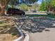 Outdoor parking lot with cars parked under trees, a car in the foreground at 3351 S Field St # 150, Lakewood, CO 80227
