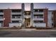 Apartment building exterior featuring multiple units with balconies, stairs, and brick accents at 14495 E 1St Dr # C2, Aurora, CO 80011