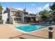 Community pool with lounge chairs and nearby clubhouse under a bright blue sky at 14495 E 1St Dr # C2, Aurora, CO 80011