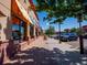 Shopping area featuring storefronts, brick sidewalks, street parking, and lush trees at 14495 E 1St Dr # C2, Aurora, CO 80011