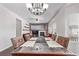 Dining room with a wooden table, chandelier, and view into the living room at 672 Pitkin Way, Castle Rock, CO 80104