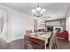 Dining room with a wooden table, chandelier, and view of a hallway at 672 Pitkin Way, Castle Rock, CO 80104