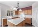 Kitchen with light countertops, wood cabinets, and an island at 672 Pitkin Way, Castle Rock, CO 80104