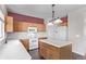 Kitchen with light countertops, wood cabinets, and an island at 672 Pitkin Way, Castle Rock, CO 80104