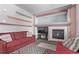 Living room with red couches, a fireplace, and a built-in entertainment center at 672 Pitkin Way, Castle Rock, CO 80104