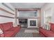 Living room with red couches, a fireplace, and a built-in entertainment center at 672 Pitkin Way, Castle Rock, CO 80104