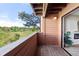 Cozy covered balcony features wood flooring and railings with lovely views of the surrounding greenery at 4274 S Salida Way # 3, Aurora, CO 80013