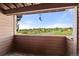 Covered balcony with neutral paint and wood floors overlooks green space at 4274 S Salida Way # 3, Aurora, CO 80013