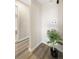 Hallway with light wood floors leading to the laundry area, highlighted by a green decorative plant at 4274 S Salida Way # 3, Aurora, CO 80013