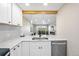 Bright kitchen with white cabinets, stainless steel appliances, and a view to the living space at 4274 S Salida Way # 3, Aurora, CO 80013