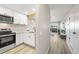 Efficiently designed kitchen with bar, stainless appliances, opening to the living room at 4274 S Salida Way # 3, Aurora, CO 80013