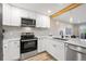 Modern kitchen with stainless appliances and bar, overlooks the open living area at 4274 S Salida Way # 3, Aurora, CO 80013