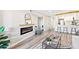 Open-concept living space with electric fireplace, seamlessly connecting to the modern kitchen at 4274 S Salida Way # 3, Aurora, CO 80013