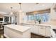 Bright kitchen featuring a center island, modern appliances, and ample counter space at 366 Elm St, Denver, CO 80220