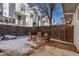 Cozy backyard featuring a fire pit, wooden chairs, and privacy fence for outdoor entertaining at 1244 S Reed St # 2, Lakewood, CO 80232