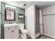 Updated bathroom with a single sink vanity, shelving and walk-in shower at 1244 S Reed St # 2, Lakewood, CO 80232