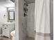 Modern bathroom featuring sleek vanity, toilet, and shower with elegant marble tile at 1244 S Reed St # 2, Lakewood, CO 80232